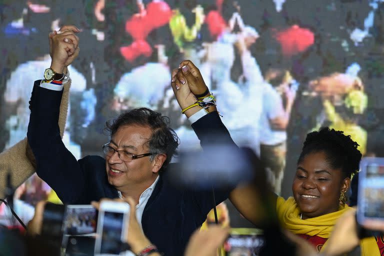 El candidato presidencial colombiano por la coalición Pacto Histórico, Gustavo Petro (L) y su compañera de fórmula Francia Márquez, celebran en la sede del partido, en Bogotá, tras la primera vuelta