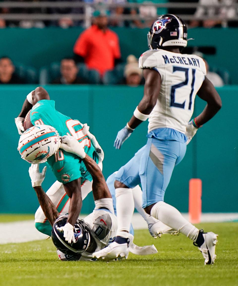 Miami Dolphins wide receiver Tyreek Hill (10) is tackled by Tennessee Titans cornerback Sean Murphy-Bunting (0) during the first quarter at Hard Rock Stadium in Miami, Fla., Monday, Dec. 11, 2023.