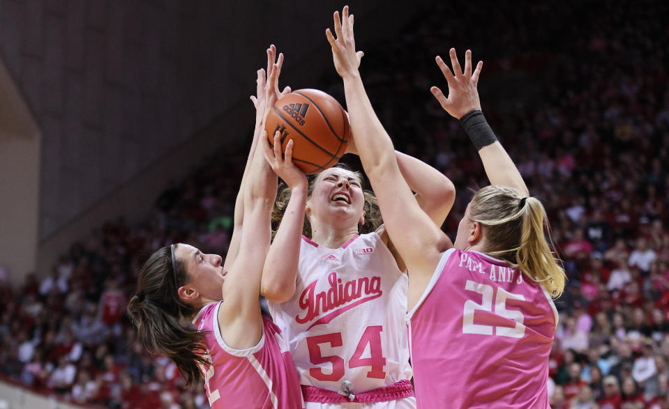 Indiana's Mackenzie Holmes goes up against Iowa defenders on Thursday at Simon Skjodt Assembly Hall in Bloomington, Indiana. (Andy Lyons/Getty Images)