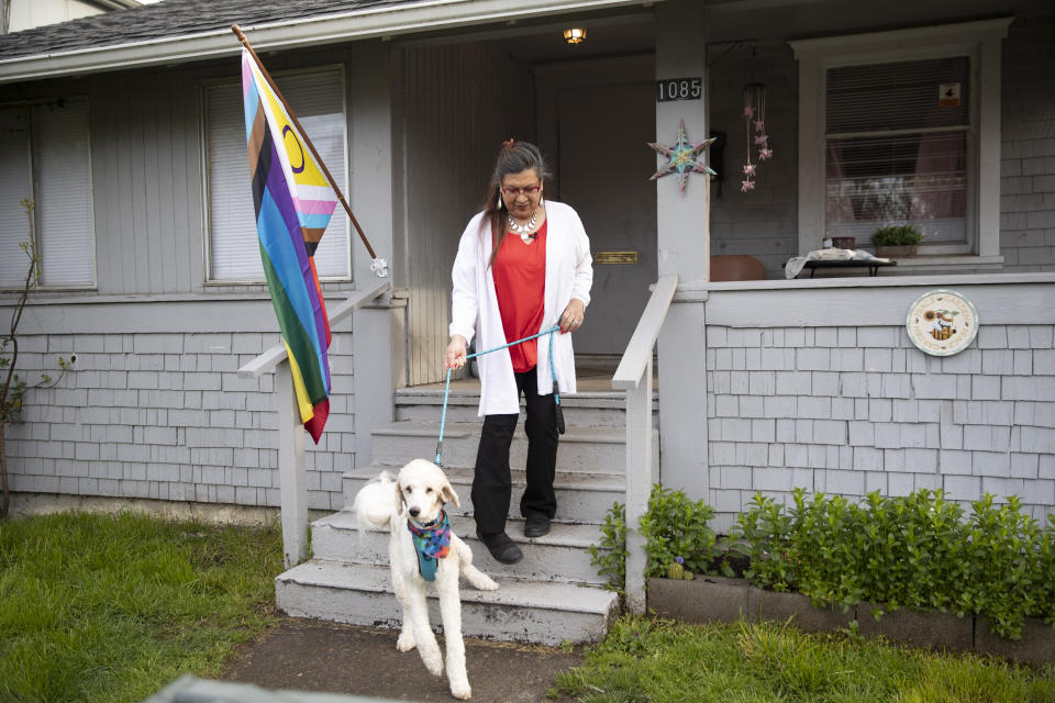 Christina Wood walks her poodle, Max, in Salem, Ore., Friday, April 21, 2023. For most of her life in New Mexico, Wood felt like she had to hide her identity as a transgender woman. So six years ago she moved to Oregon, where she could access the gender-affirming health care she needed to live as her authentic self. (AP Photo/Amanda Loman)