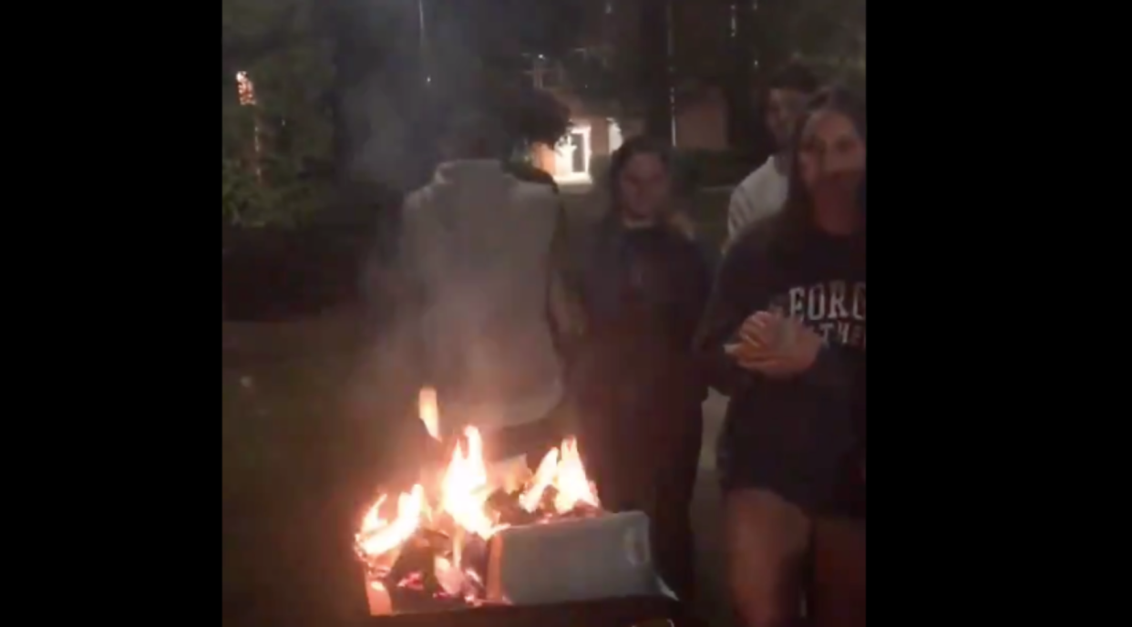 A group of students at Georgia Southern University burn copies of "Make Your Home Among Strangers" after they believed the author, Jennine Capó Crucet, unfairly "dissed" white people. (Photo: Twitter)