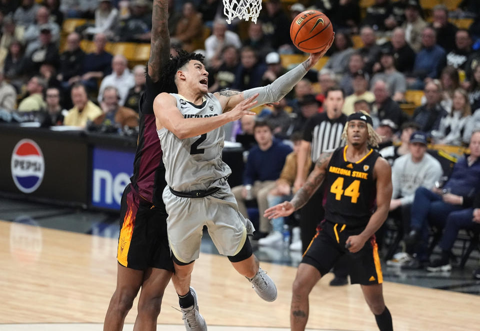 Colorado guard KJ Simpson (2) drives to the basket as Arizona State forward Alonzo Gaffney, back left, and guard Adam Miller (44) defend in the second half of an NCAA college basketball game Thursday, Feb. 8, 2024, in Boulder, Colo. (AP Photo/David Zalubowski)