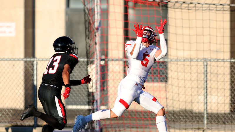 American Fork’s Davis Andrews reaches up for a long pass and touchdown ahead of West’s Lava Vailahi as the two teams play in Salt Lake City on Friday, Aug. 25, 2023. AF won 45-21.