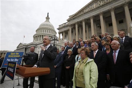 U.S. Senate Majority Leader Harry Reid (D-NV) gathers with other Democratic Party senate members on the Steps of the U.S. Capitol in Washington, October 9, 2013. REUTERS/Jason Reed
