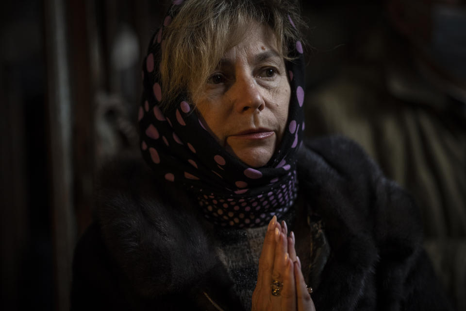 A Christian worshiper prays during Sunday mass in the Saints Peter and Paul Garrison Church in Lviv, western Ukraine, Sunday, March 6, 2022. The memorial is dedicated to the Ukrainian soldiers who died after 2014. (AP Photo/Bernat Armangue)