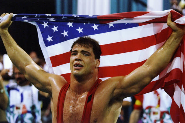 Kurt Angle holds up the American flag at the Summer Olympics in Atlanta, Georgia.