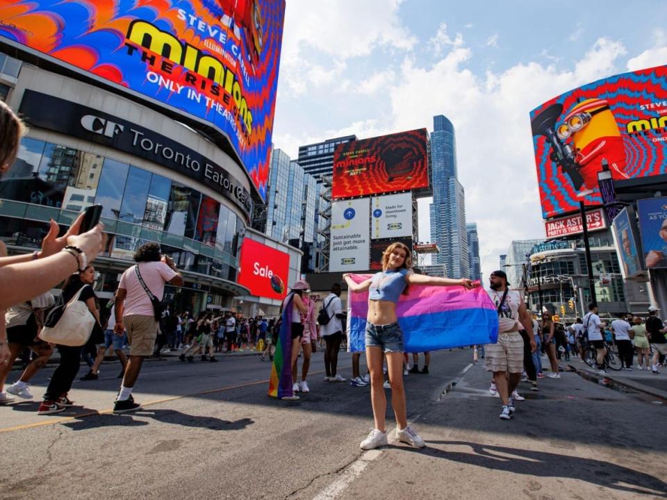 Revellers march down Toronto&#x002019;s Yonge Street for the annual Pride parade on June 26, 2022. Festival organizers have raised concern about the rising cost of security for the event.  (Evan Mitsui/CBC - image credit)