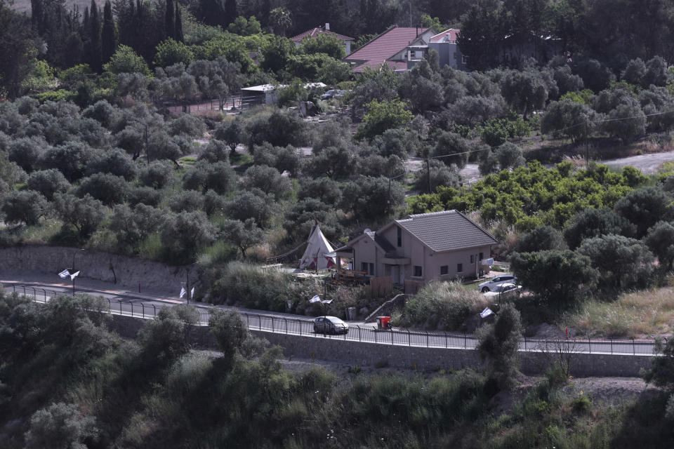 A car drives along the Israeli village of Metulla, as seen from the Lebanese-Israeli border, in the village of Kfar Kila, in southeast Lebanon, Wednesday, May 20, 2020. Twenty years after Hezbollah guerrillas pushed Israel's last troops from southern Lebanon, both sides are gearing up for a possible war that neither seems to want. (AP Photo/Bilal Hussein)