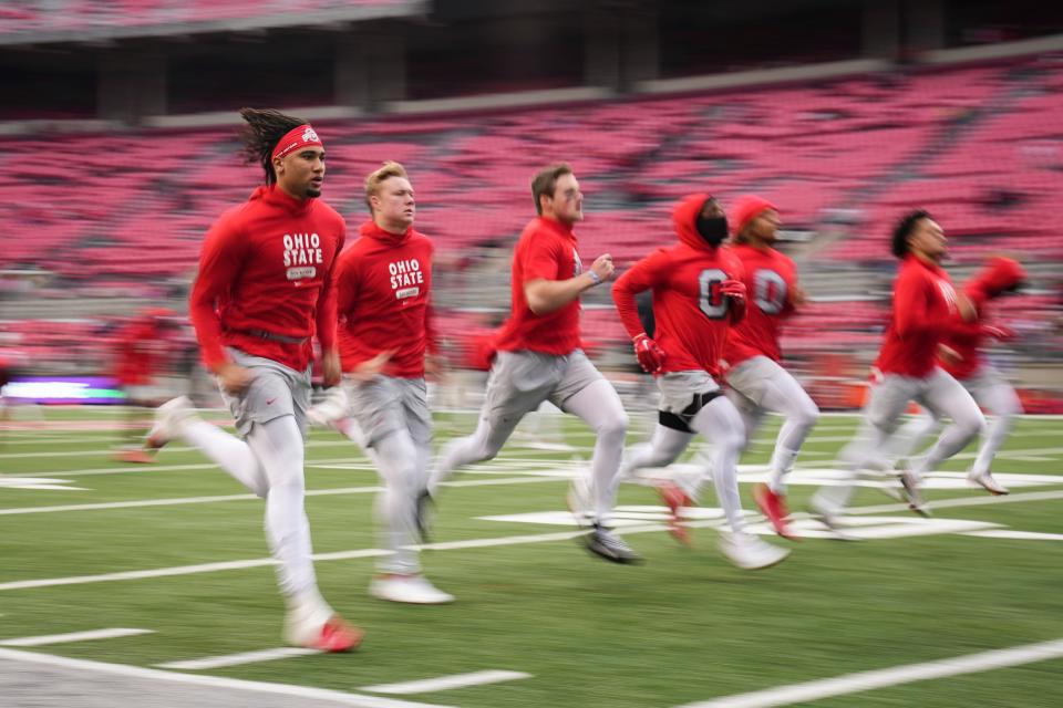 Nov 12, 2022; Columbus, Ohio, USA;  Ohio State Buckeyes quarterback C.J. Stroud (7) warms up alongside other quarterbacks and receivers during the second half of the NCAA football game against the Indiana Hoosiers at Ohio Stadium. Mandatory Credit: Adam Cairns-The Columbus Dispatch