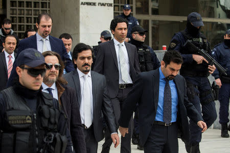 The eight Turkish soldiers, who fled to Greece in a helicopter and requested political asylum after a failed military coup against the government, are escorted by police officers as they leave the Supreme Court in Athens, Greece, January 23, 2017. REUTERS/Alkis Konstantinidis