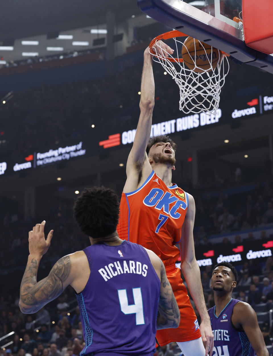 Feb 2, 2024; Oklahoma City, Oklahoma, USA; Oklahoma City Thunder forward Chet Holmgren (7) dunks in front of Charlotte Hornets center Nick Richards (4) during the first quarter at Paycom Center. Mandatory Credit: Alonzo Adams-USA TODAY Sports