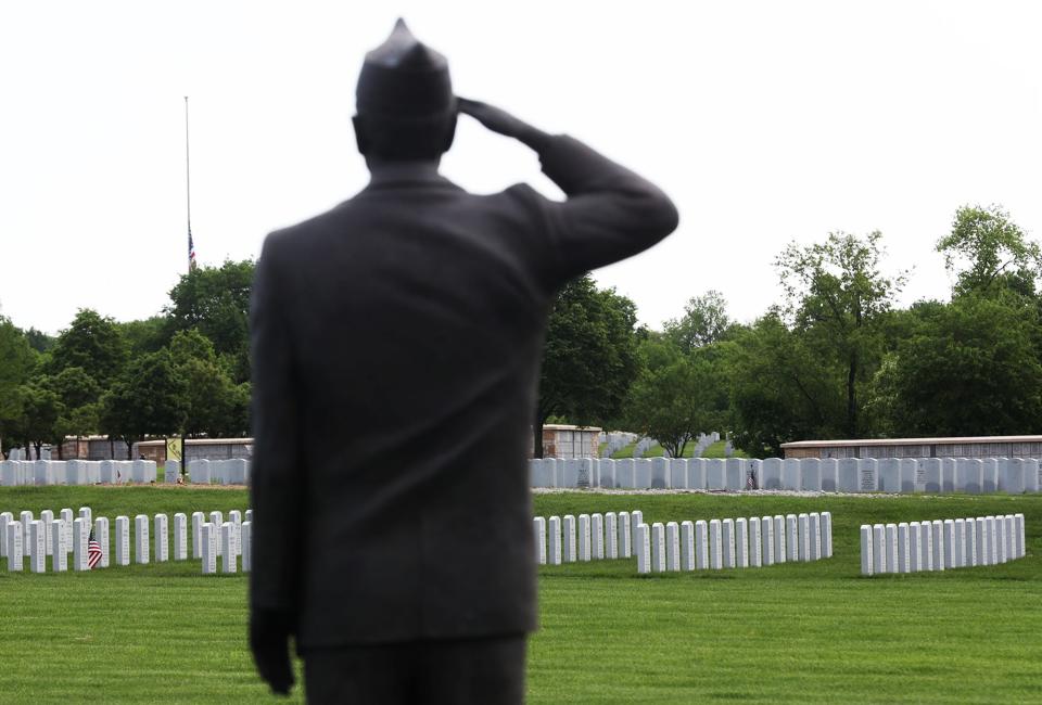 A statue of a citizen soldier salutes graves at Ohio Western Reserve National Cemetery in Rittman.