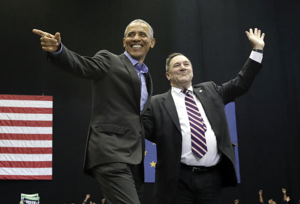 CORRECTS TO SAY THAT DONNELLY IS A CONGRESSIONAL CANDIDATE, NOT A GUBERNATORIAL CANDIDATE - Former President Barack Obama, left, points as Democratic congressional candidate U.S. Sen. Joe Donnelly waves to the crowd during a campaign rally at Genesis Convention Center in Gary, Ind., Sunday, Nov. 4, 2018. (AP Photo/Nam Y. Huh)