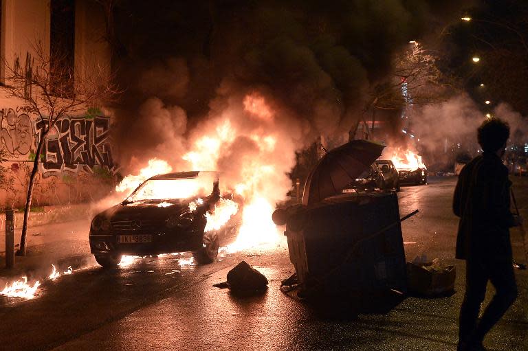 A car burns in central Athens' Exarchia district after it was set on fire by young anarchists on February 26, 2015