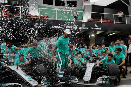 Formula One F1 - Brazilian Grand Prix - Autodromo Jose Carlos Pace, Interlagos, Sao Paulo, Brazil - November 11, 2018 Mercedes' Lewis Hamilton and team members celebrate after winning the constructors championship REUTERS/Ricardo Moraes