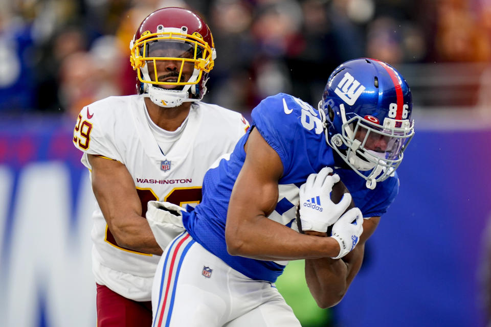 New York Giants wide receiver Darius Slayton (86) comes down with touchdown pass against Washington Football Team cornerback Kendall Fuller (29) during the fourth quarter of an NFL football game, Saturday, Jan. 9, 2021, in East Rutherford, N.J. (AP Photo/Frank Franklin II)