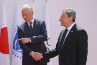 French Finance Minister Bruno Le Maire, left, welcomes European Central Bank President Mario Draghi at the G-7 Finance Wednesday July 17, 2019.The top finance officials of the Group of Seven rich democracies are arriving at Chantilly, at the start of a two-day meeting aimed at finding common ground on how to tax technology companies and on the risk from new digital currencies. (AP Photo/Michel Euler)