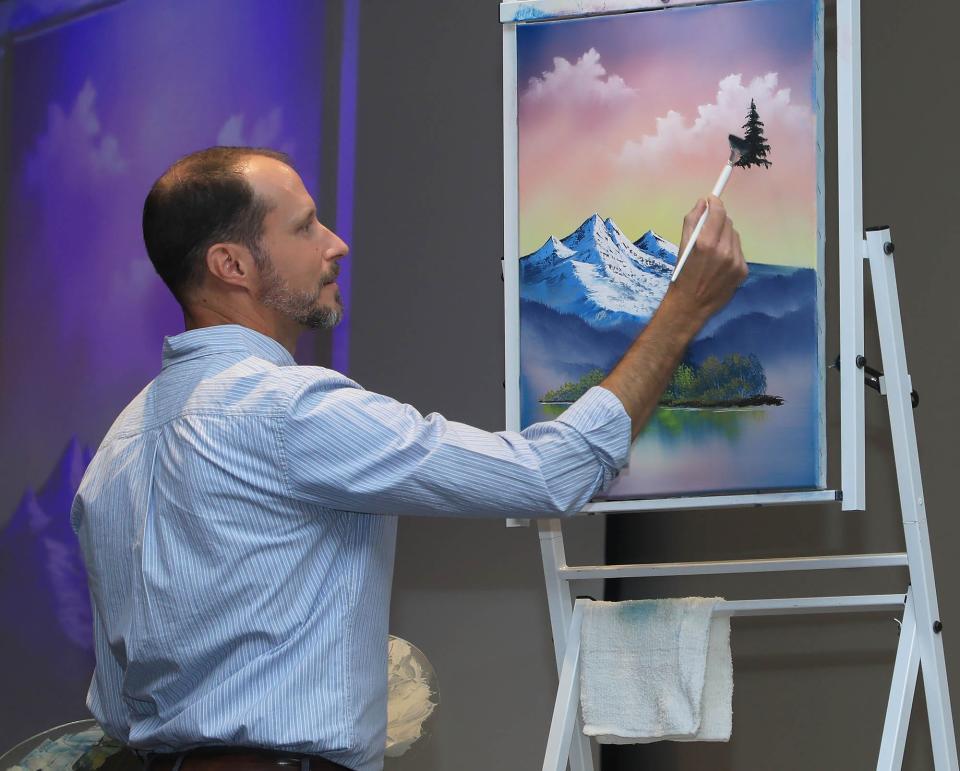 Nicholas Hankins chats about his life and paints live in front of an audience during the The Joy of Painting event, Thursday, April 4, 2024.