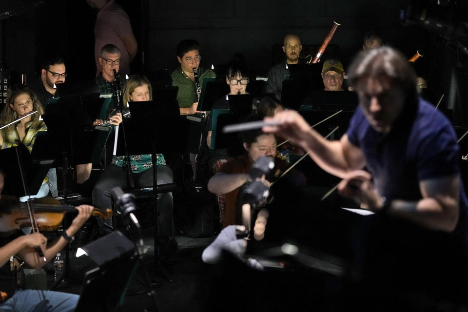 Ballet Arizona musicians rehearse with Guest Conductor Gavriel Heine, right, for the "Nutcracker", Thursday, Dec. 7, 2023, in Phoenix prior to an upcoming performance. A pit full of musicians is part of the tradition of the holiday staple for Ballet Arizona and many other productions around the world. Shows use recordings as they weather costs or crises like recessions. But fans, musicians and the unions that represent them say the live music brings an unseen signature to each show. (AP Photo/Matt York)