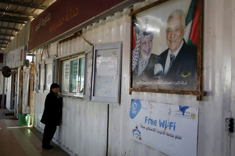 Christian Palestinian woman waits to receive a permit to leave Gaza through Israeli Erez crossing heading to Bethlehem to attend Christmas celebrations, in the northern Gaza Strip