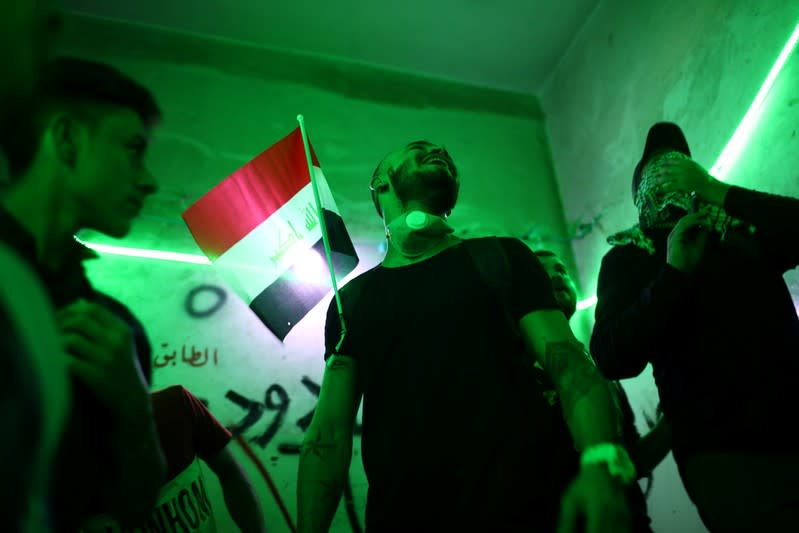 Iraqi demonstrators are seen inside the high-rise building, called by Iraqi the Turkish Restaurant Building, during anti-government protests in Baghdad