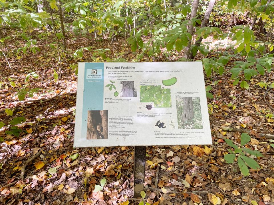 Signs throughout Latimer Woods, a small piece of land in Bloomington that has old-growth trees, tells about the family who donated the land as well as the flora.