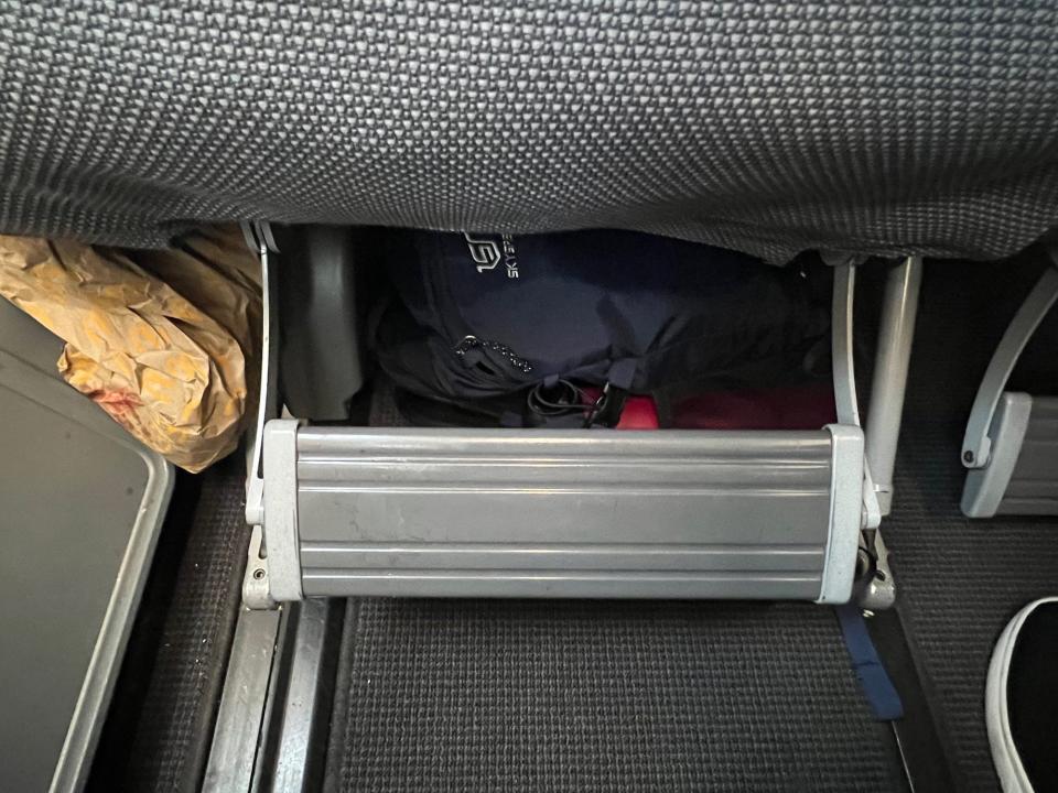 The gray footrest pulled out from under the seat.