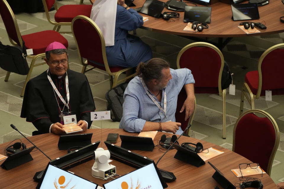 Activist Luca Casarin, right, arrives for the opening session of the 16th General Assembly of the Synod of Bishops in the Paul VI Hall at The Vatican, Wednesday, Oct. 4, 2023. Pope Francis is convening a global gathering of bishops and laypeople to discuss the future of the Catholic Church, including some hot-button issues that have previously been considered off the table for discussion. Key agenda items include women's role in the church, welcoming LGBTQ+ Catholics, and how bishops exercise authority. For the first time, women and laypeople can vote on specific proposals alongside bishops. (AP Photo/Gregorio Borgia)