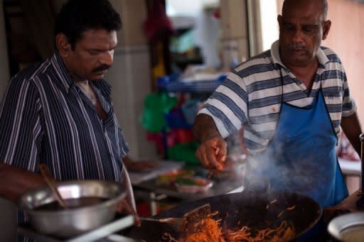 Mahboob Zakaria (R) prepares mee goreng at his stall in Georgetown, the state of Penang's capital city. Mahboob is an ethnic Indian Muslim whose family has sold its delicious mee goreng -- thin noodles fried with a smoky tomato-chili sauce, squid, potato, and other ingredients, for more than 80 years