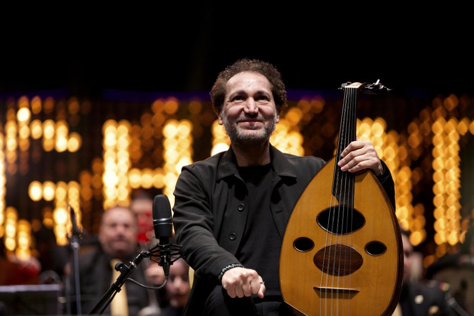 Iraqi virtuoso oud player Naseer Shamma prepares to perform with an orchestra, at the Iraqi National Theater in Baghdad, Iraq, Friday, Jan. 21, 2022. War kept him away from his beloved homeland for decades. Now Shamma has returned to Iraq with a series of concerts and projects he hopes will support education, culture and the arts in the conflict-scarred nation. (AP Photo/Hadi Mizban)