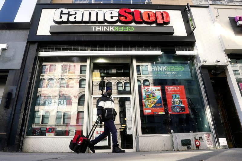 FILE PHOTO: FILE PHOTO: A person walks past a GameStop in New York