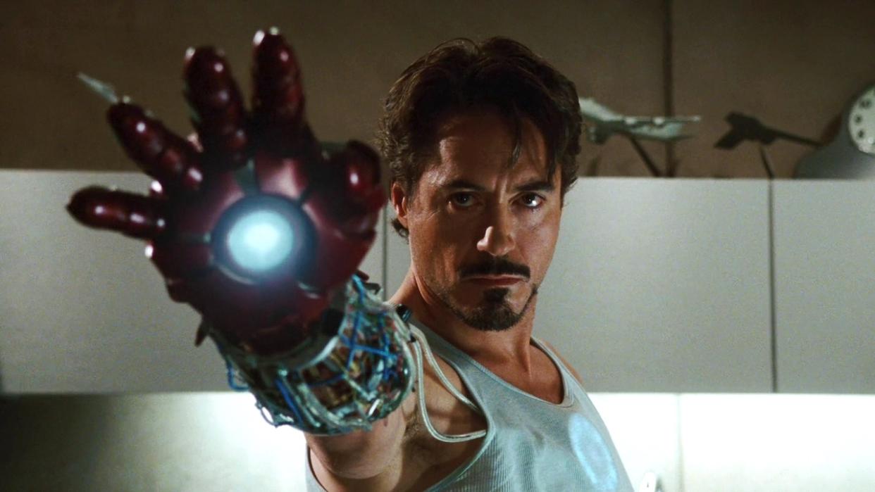  Robert Downey Jr. wearing Iron Man gauntlet. 