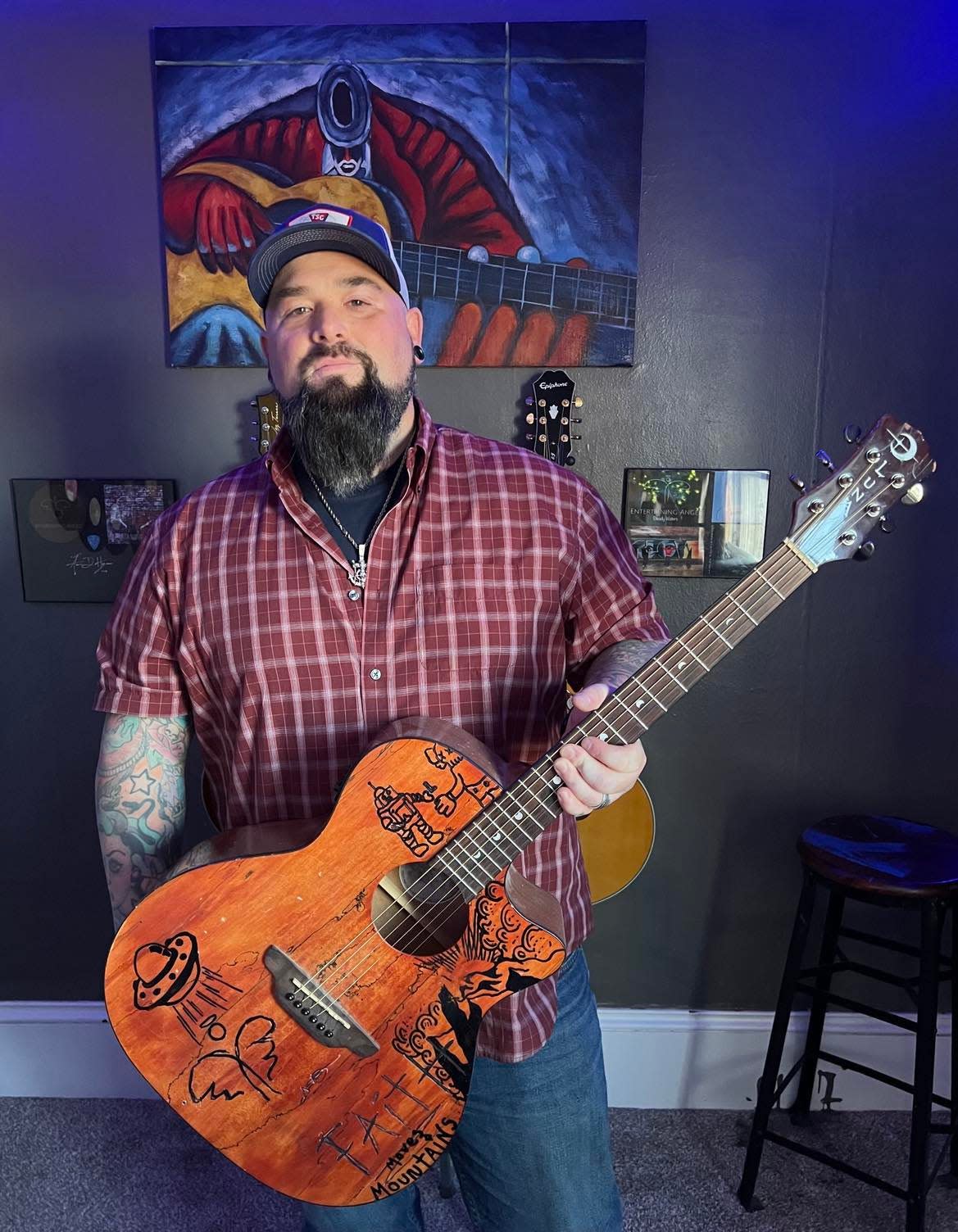 Aaron Hymes, a Stark County resident and Christian country music artist, is shown at his home where he rehearses with his band, which recently signed a Nashville-based recording contract. Hymes is also an associate pastor at an East Canton area church.