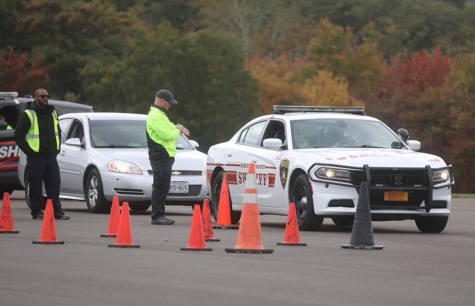 Students in the Southern Tier Law Enforcement Academy practice driving skills at the runway at the National Soaring Museum in Elmira. Elmira Police Sgt. Andrew Hughson, getting ready to start his timer, tells the next cadet to start the course while Elmira Police Officer Bryant Tranchant looks out at the course.