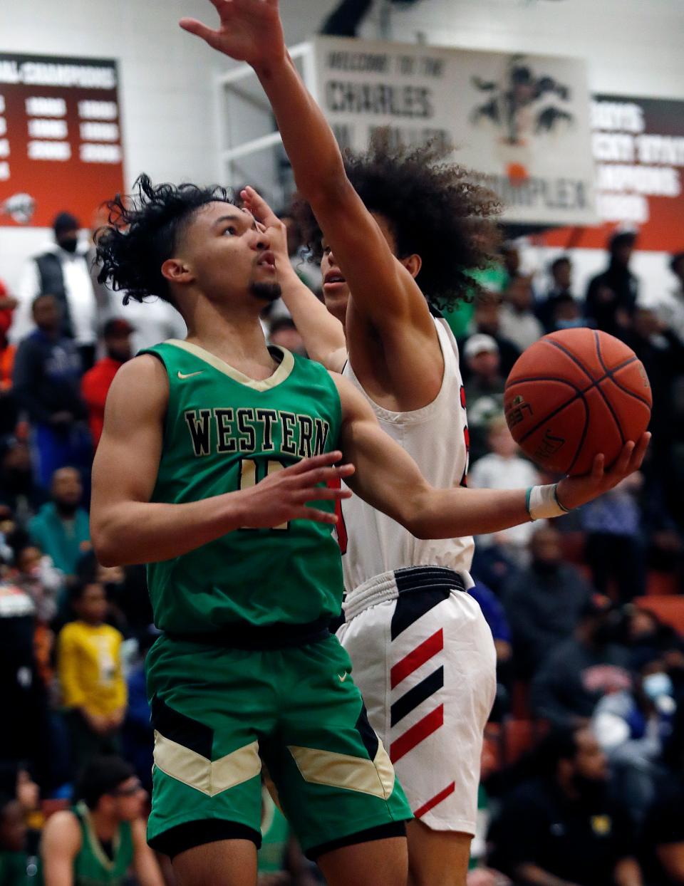 Western’s Trent Hinkle tries to make the bucket against Pleasure Ridge Park but gets the foul. Feb. 18, 2022