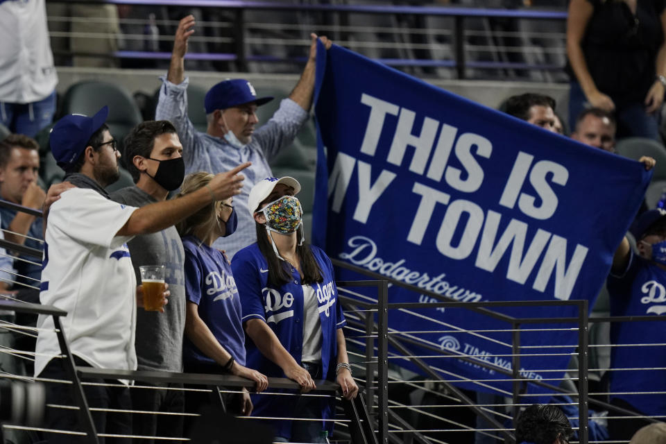 Los Angeles Dodgers fans watch during the seventh inning in Game 1 of the baseball World Series against the Tampa Bay Rays Tuesday, Oct. 20, 2020, in Arlington, Texas. (AP Photo/Eric Gay)