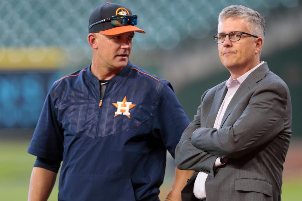 Manager A.J. Hinch #14 of the Houston Astros and general manager Jeff Luhnow talk during batting practice at Minute Maid Park on April 4, 2017 in Houston, Texas.