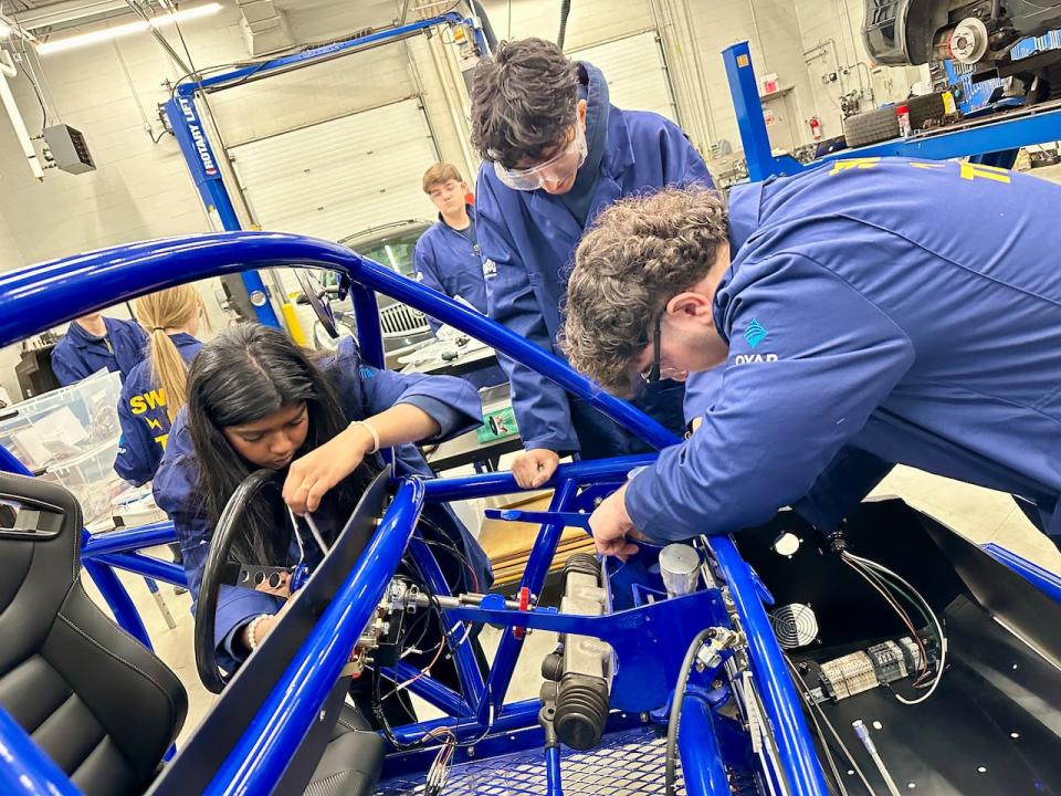 Automotive students at St. Anne Catholic High School in Lakeshore work on the school's new Switch electric vehicle kit. Photographed Dec. 14, 2023.