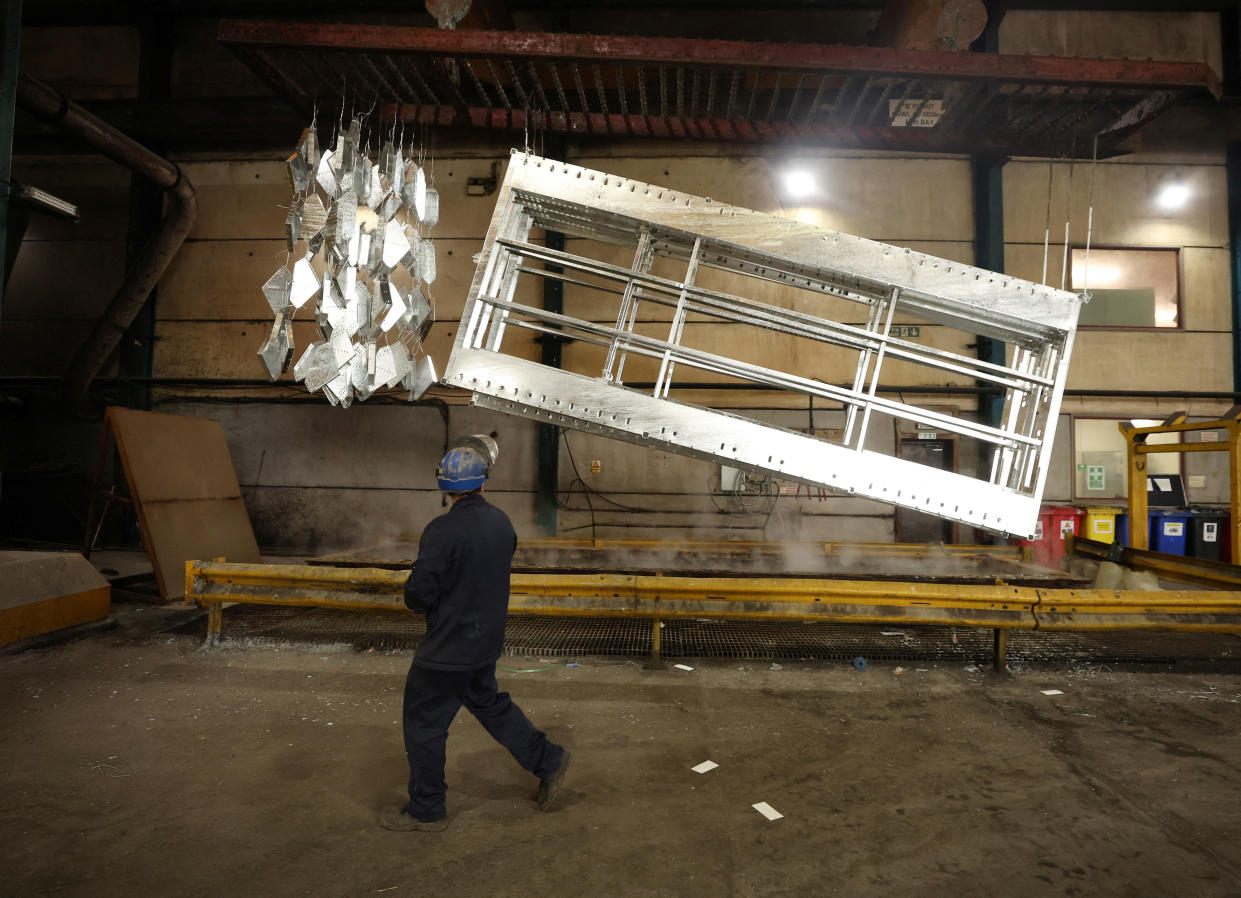 recession  A worker walks past freshly galvanised pieces of metal inside the factory of Corbetts The Galvanizers in Telford, Britain, June 28, 2022. REUTERS/Phil Noble