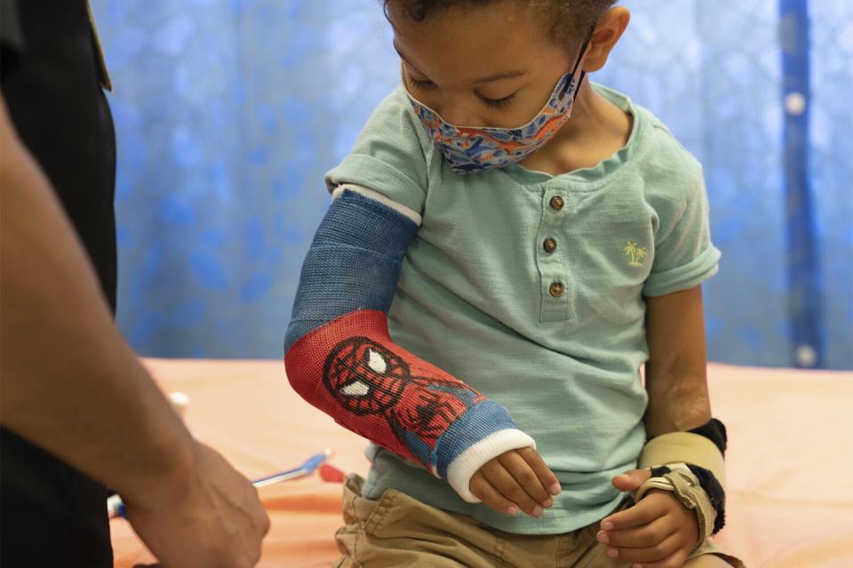 Luis Ruiz, An orthopaedic technician at Children’s Hospital Los Angeles draws fun drawings on casts... The little boy is Forrest Greene, 6. He loves Spiderman and received his cast on July 11, 2022. Photo credit: Courtesy of Children’s Hospital Los Angeles.