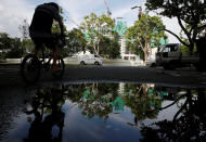 A man cycles past a construction site where locally transmitted Zika cases were first discovered in Singapore August 31, 2016. REUTERS/Edgar Su/File Photo