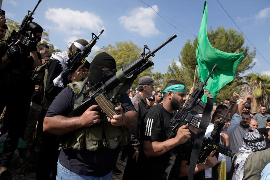 Palestinian militants attend a funeral of people killed during an Israeli military raid on a Palestinian refugee camp, Nur Shams, in the West Bank on Friday, Oct. 20, 2023. (AP Photo/Majdi Mohammed)