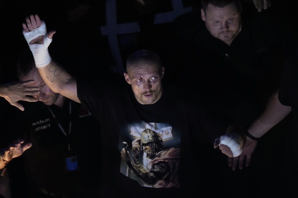 Oleksandr Usyk of Ukraine waves to spectators after his unanimous decision victory over Anthony Joshua of Britain in their WBA (Super), WBO and IBF boxing title bout at the Tottenham Hotspur Stadium in London, Saturday, Sept. 25, 2021. (AP Photo/Frank Augstein)