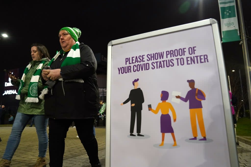 Celtic fans pass Covid-19 signs at the Premiership match at Celtic Park, Glasgow (Andrew Milligan/PA) (PA)