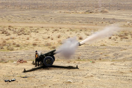 Afghan troops fire a 122mm howitzer during a live-fire exercise with NATO military advisers outside Kandahar Air Field, Afghanistan, February 15, 2017. Picture taken February 15, 2017. REUTERS/Josh Smith