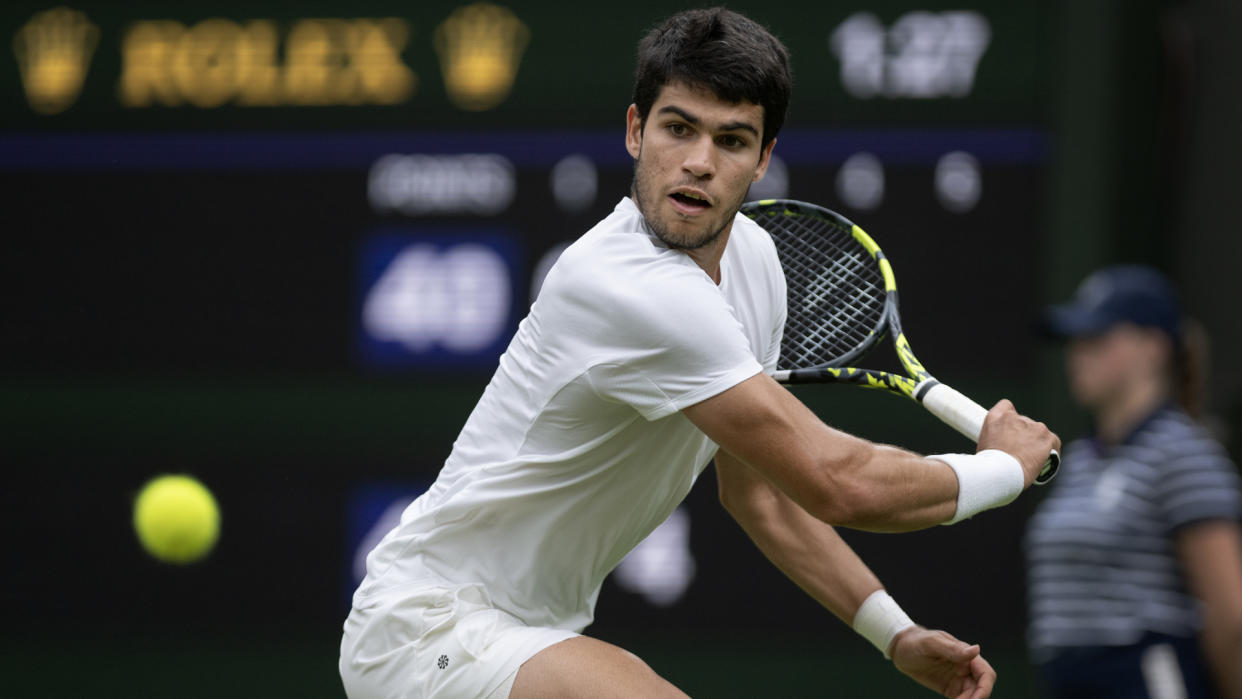  Carlos Alcaraz winds up a backhand at Wimbledon 