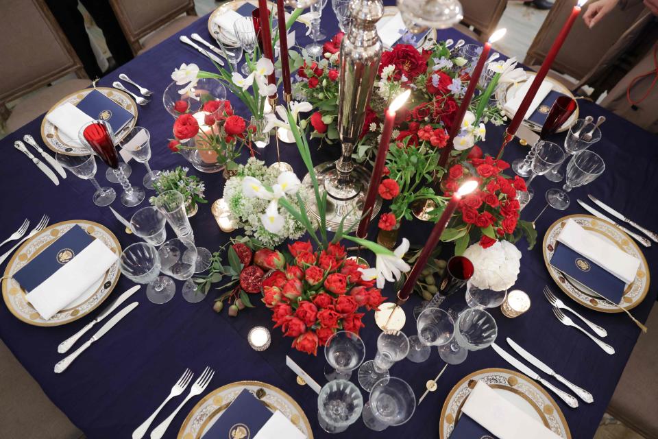 A table is set during a media preview ahead of the state dinner in honor of French President Emmanuel Macron, in the State Dining Room of the White House, on Nov. 30, 2022.