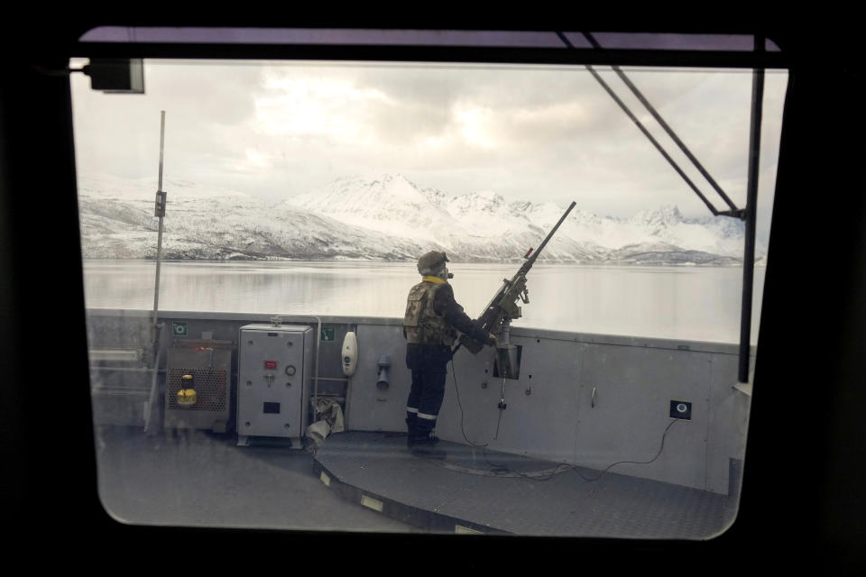 A French sailor on the bridge of the French navy frigate Normandie stands guard as the vessel patrols in a Norwegian fjord, north of the Arctic circle, for a reconnaissance patrol, Wednesday March 6, 2024. The French frigate is part of a NATO force conducting exercises in the seas, north of Norway, codenamed Steadfast Defender, which are the largest conducted by the 31 nation military alliance since the cold war.(AP Photo/Thibault Camus)