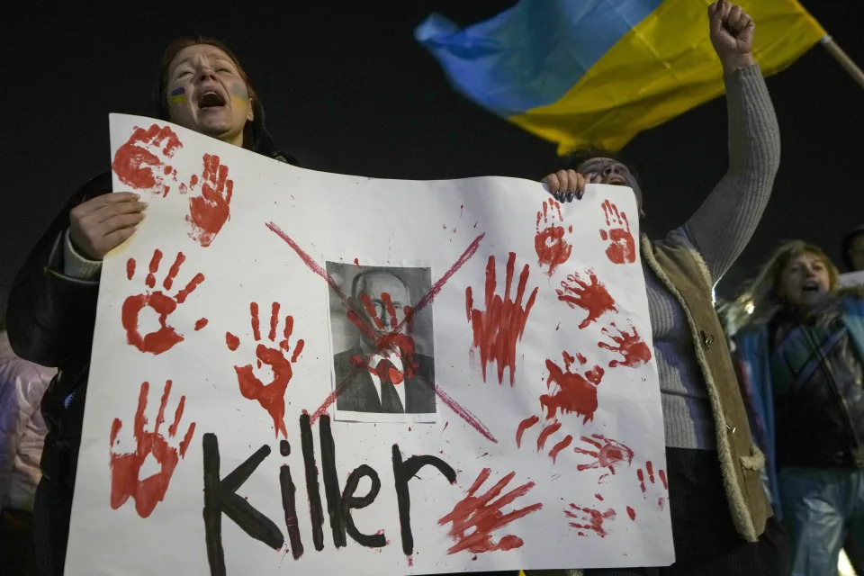 Women hold a placard against Russian President Vladimir Putin as they attend a pro-Ukraine protest against Russia's invasion of Ukraine in Tel Aviv, Israel, Thursday, March 3, 2022. (AP Photo/Ariel Schalit)