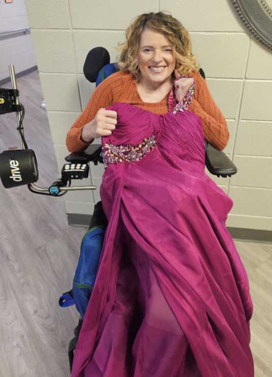 Laura Holder, 51, holds the prom dress she will wear to The Ivy at Gastonia's May prom.